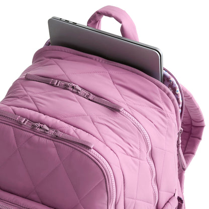 Purple backpack with a laptop inside on a white background