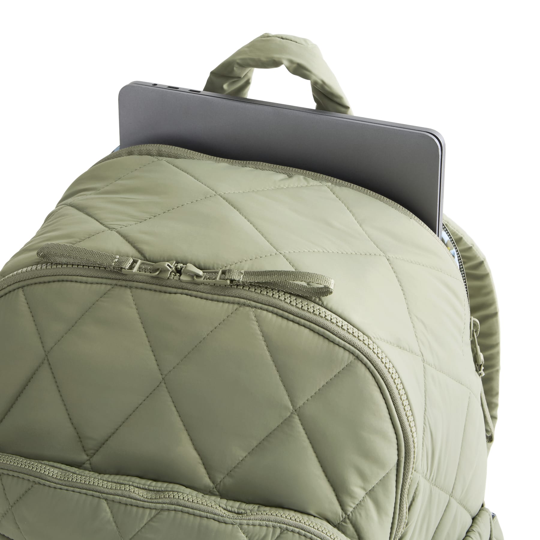 Green quilted backpack with a laptop inside on a white background