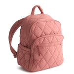 Pink quilted backpack on a white background