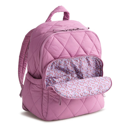 Pink quilted backpack with floral interior on a white background