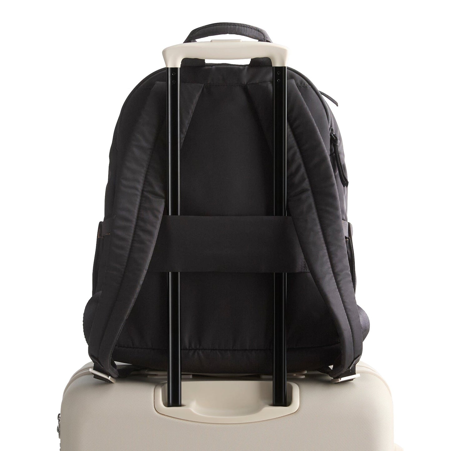 Black backpack with wheels attached to a beige suitcase on a white background